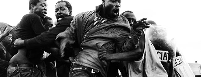 Melilla, Spain, April 24th 2014. Some 20 subsaharan migrants manage to escape from the Police and star running through the fields next to the border. Despite the fact that these migrants had the right to stay in Spain since they touch Spanish soil, the Guardia Civil and the Police  illegally expatriate most of the 100 migrants who attempt to cross the fence.